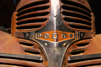 Close-up of vintage rusty Dodge truck grille emblem