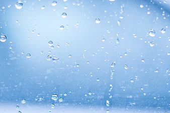 Blue Raindrops on Glass Window Background