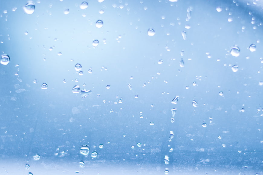 Blue Raindrops on Glass Window Background