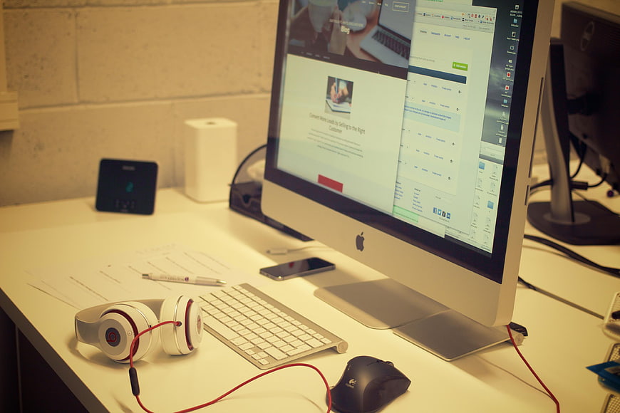 Modern Office Desk with Computer and Headphones