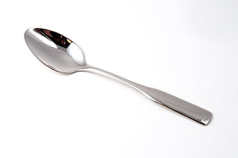 Silver metal spoon on white background