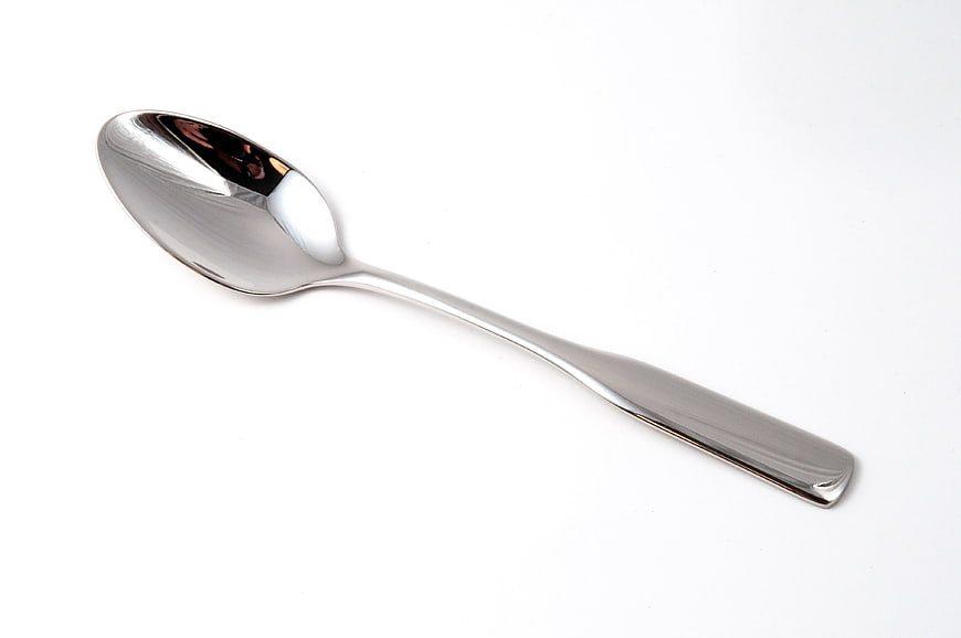 Silver metal spoon on white background
