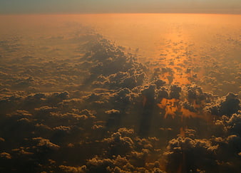 Aerial View of Golden Sunset Above Clouds