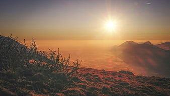 Golden Sunrise Over Mountain Peaks and Sea of Clouds