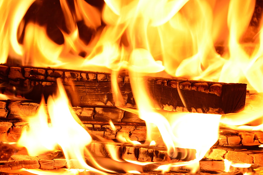 Close-up of burning logs in a warm fireplace