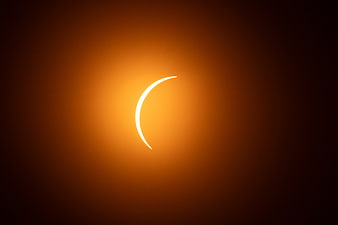 Crescent Solar Eclipse with Golden Orange Glow