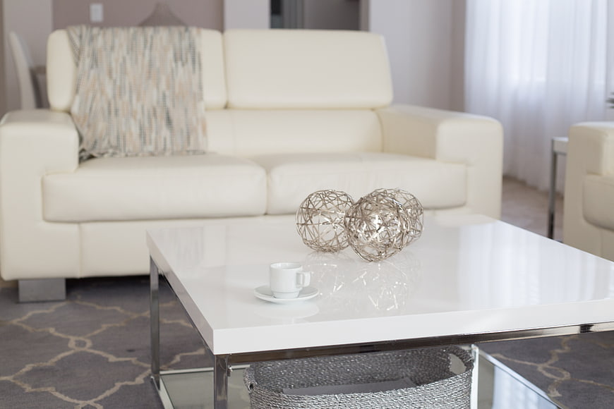 Modern white living room interior with coffee table and sofa