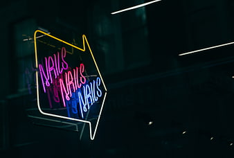 Neon Nails Sign in Dark Window