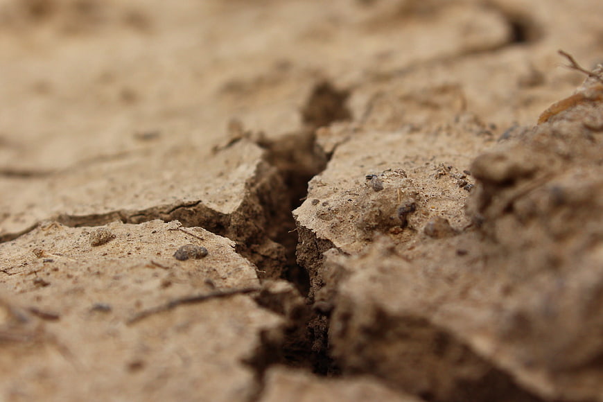 Close-up of cracked dry earth soil texture