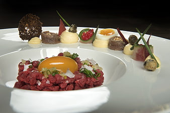 Gourmet Beef Tartare with Raw Egg Yolk and Garnishes