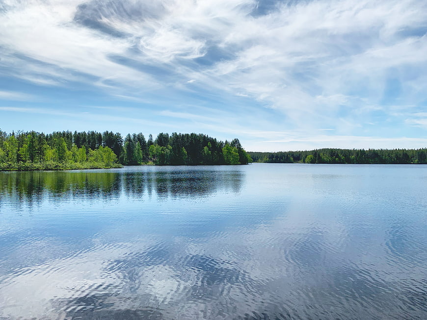 Serene Lake Landscape with Forest Reflection and Blue Sky