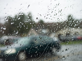 Raindrops on Car Window with Blurred Background