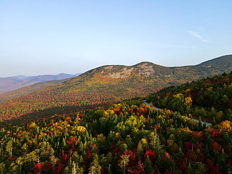 Scenic autumn mountain landscape with colorful foliage and winding road