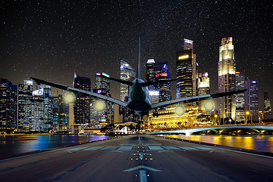 Airplane Landing on City Runway Under Starry Night Sky