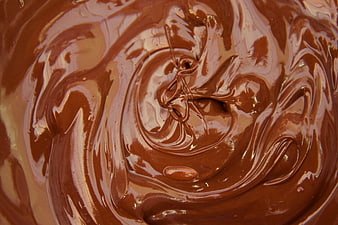 Close-up of swirling melted milk chocolate texture