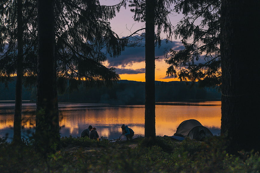 Camping by Lake at Sunset with Tent and People