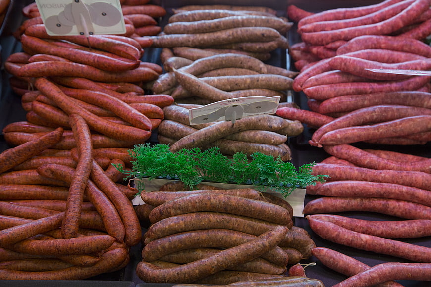 Assorted Fresh Sausages Displayed In Butcher Shop Deli