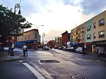Colorful Urban Street Scene at Dusk with Pedestrians