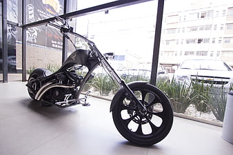 Custom Black Chopper Motorcycle Displayed in Showroom
