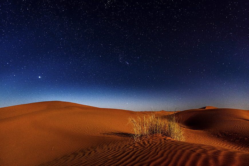 Starry Night Sky Over Orange Sand Dunes Desert Landscape