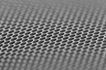 Close-up of perforated metal mesh texture background