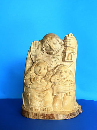 Wooden Nativity Sculpture on Blue Background