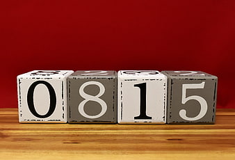 Wooden Number Blocks 0815 on Wooden Surface Against Red Background