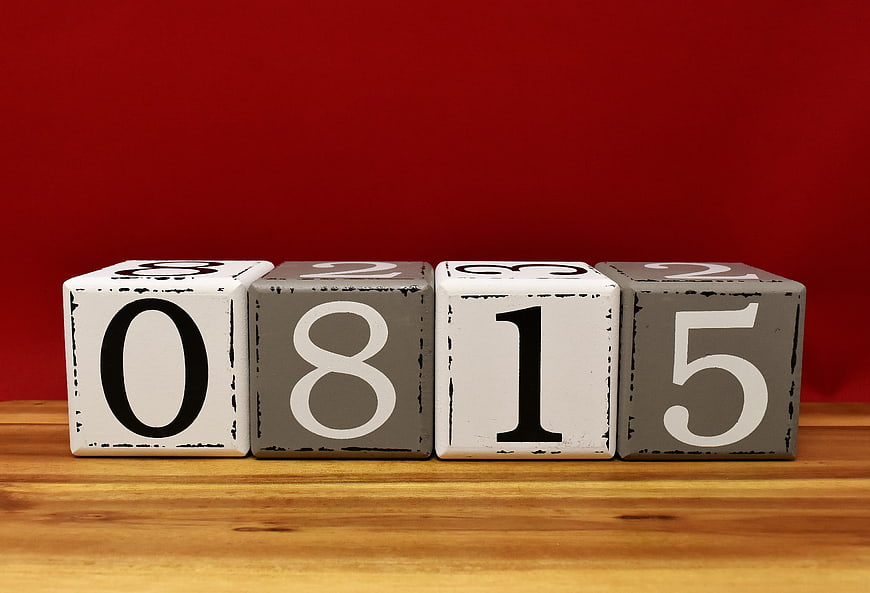 Wooden Number Blocks 0815 on Wooden Surface Against Red Background