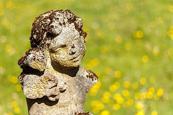 Mossy Stone Angel Sculpture in Green Garden