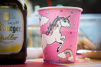 Pink Unicorn Paper Cup And Beer Bottle On Table