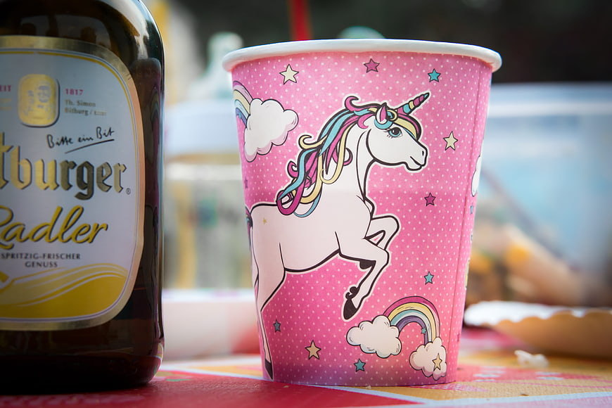 Pink Unicorn Paper Cup And Beer Bottle On Table