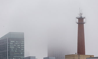 Foggy Urban Cityscape with Brick Tower and Glass Building