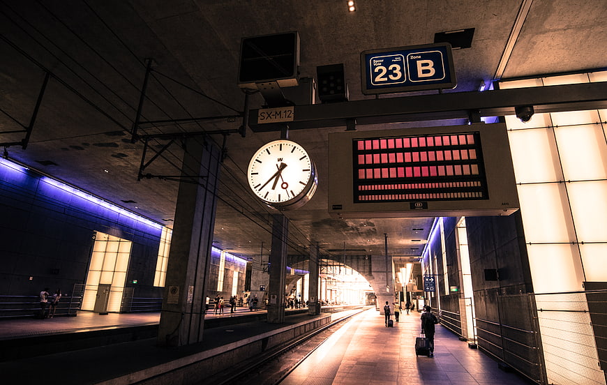 Modern Train Station Platform with Clock and Digital Signage