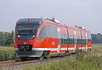 Red Regional Express Train Traveling Through Countryside