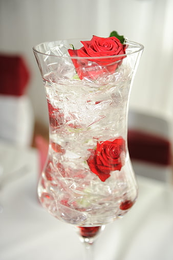 Elegant red roses in ice-filled glass vase centerpiece