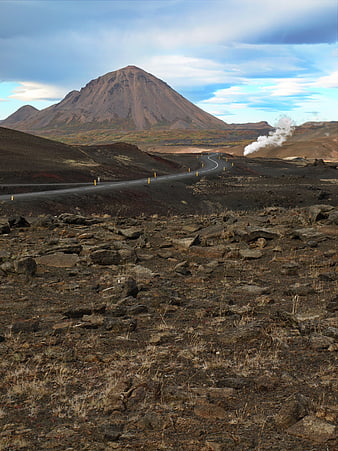 Winding Road Through Volcanic Landscape with Mountain and Steam
