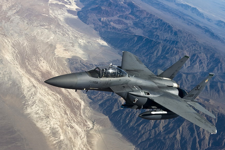 F-15 Strike Eagle Fighter Jet Flying Over Desert Mountains