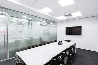 Modern empty conference room with glass walls and white table