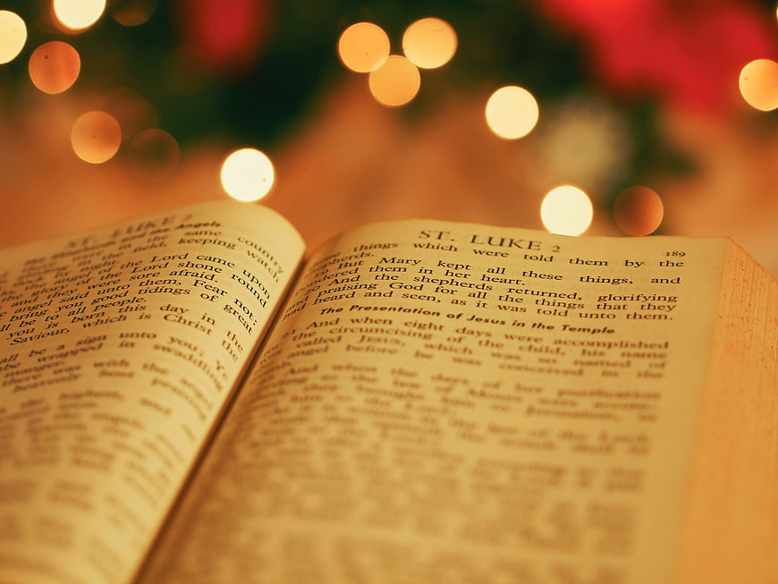 Open Bible with Christmas Lights and Bokeh Background