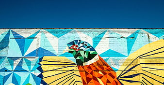 Colorful Geometric Bird Mural on Brick Wall