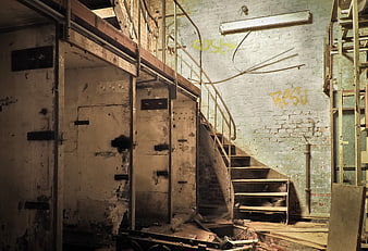 Abandoned Industrial Factory Interior With Staircase And Graffiti