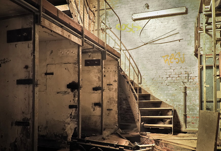 Abandoned Industrial Factory Interior With Staircase And Graffiti
