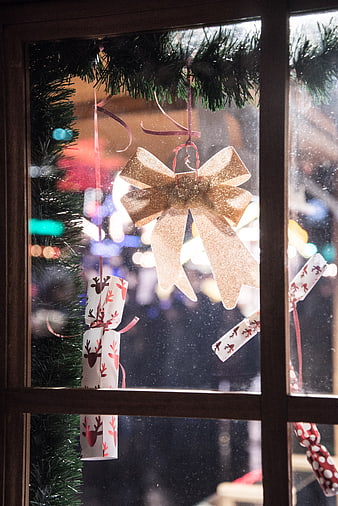 Christmas Window Display with Gold Bow and Cracker Ornaments