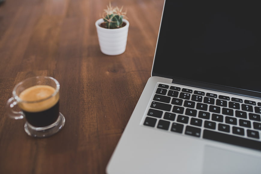 Laptop and Espresso Coffee on Wooden Desk