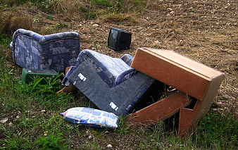 Illegal Furniture Dumping In Rural Field