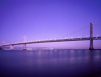 Long exposure of illuminated suspension bridge at twilight