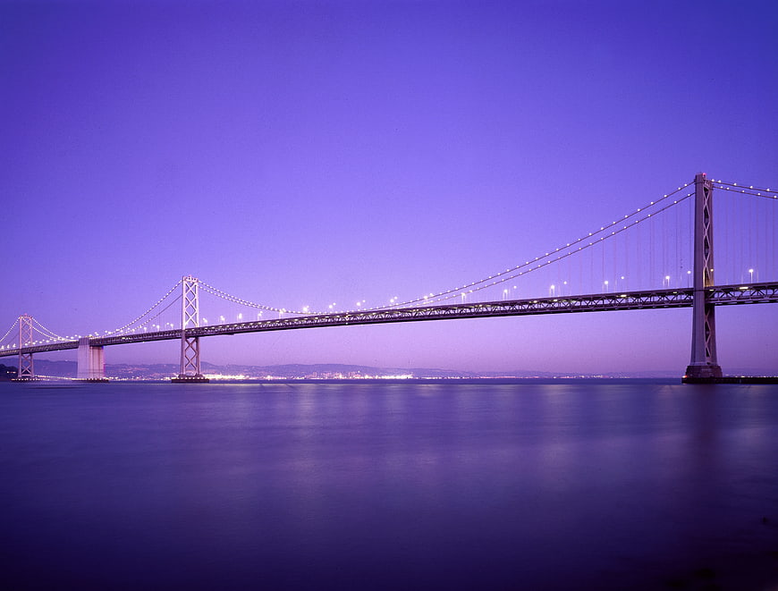 Long exposure of illuminated suspension bridge at twilight