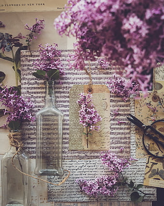 Vintage purple lilac flowers on sheet music background