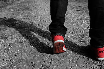 Red Nike Sneakers Walking on Gravel Path