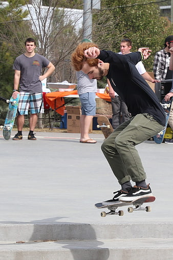Skateboarder performing mid-air trick at outdoor skate park